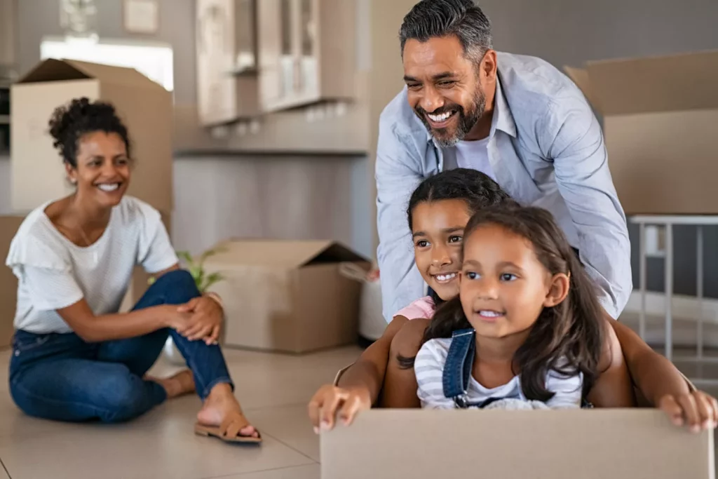 Family enjoying playtime with cardboard box at home