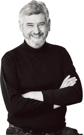 Smiling man in black turtleneck with arms crossed