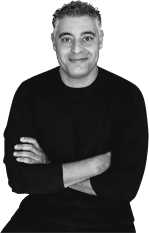 Man in black shirt smiling, arms crossed