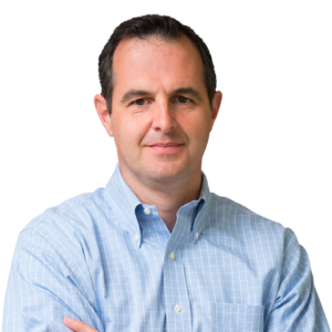 Smiling man in blue checkered shirt with arms crossed