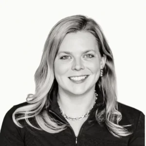 Black and white portrait of smiling woman with necklace